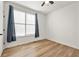 Inviting bedroom with hardwood floors and a window with neutral-toned curtains at 720 Perch Pl, Atlanta, GA 30312