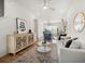 Open-concept living space with hardwood floors, modern decor, and a kitchen in the background at 720 Perch Pl, Atlanta, GA 30312
