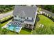 An aerial of a modern home with a pool, lounge chairs, and well-manicured yard at 100 Chateau Pl, Woodstock, GA 30188