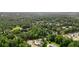 Sprawling view of a neighborhood from above, surrounded by trees and lush greenery at 100 Chateau Pl, Woodstock, GA 30188