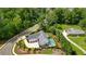 Stunning aerial view of a modern home with a pool, lush landscaping, and a three-car garage at 100 Chateau Pl, Woodstock, GA 30188