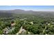 A stunning aerial view of a large property with a pond and lush green landscape at 100 Chateau Pl, Woodstock, GA 30188