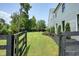 Scenic view through fence onto a expansive backyard, complemented by a fire pit area and lush green grass at 100 Chateau Pl, Woodstock, GA 30188