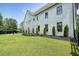 Well-kept backyard featuring a verdant lawn, manicured landscaping, and a rear exterior view of the house at 100 Chateau Pl, Woodstock, GA 30188