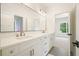 Bathroom featuring dual sinks, quartz counters, and modern fixtures at 100 Chateau Pl, Woodstock, GA 30188