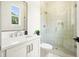 Bright bathroom with a glass-enclosed shower, modern vanity, and a window with natural light at 100 Chateau Pl, Woodstock, GA 30188