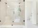 Luxurious glass shower boasts rainfall head, seating and bright tile at 100 Chateau Pl, Woodstock, GA 30188