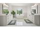 Bright bathroom featuring a soaking tub, dual vanities, and natural lighting at 100 Chateau Pl, Woodstock, GA 30188