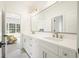 Bright bathroom boasts dual sinks, white cabinetry, and a large mirror at 100 Chateau Pl, Woodstock, GA 30188