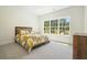 Sun-filled bedroom with a large window and neutral decor and furniture at 100 Chateau Pl, Woodstock, GA 30188