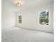 Spacious, bright bedroom with plush carpet and natural light from two large windows at 100 Chateau Pl, Woodstock, GA 30188