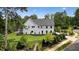 Lovely two-story home with a manicured lawn, lush landscaping, and a charming pool area for relaxation at 100 Chateau Pl, Woodstock, GA 30188