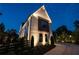 Striking exterior view of a white brick home with black-framed windows at twilight at 100 Chateau Pl, Woodstock, GA 30188