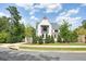 Charming home with a manicured front yard, lush landscaping, and classic architectural details at 100 Chateau Pl, Woodstock, GA 30188