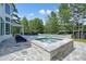 Backyard hot tub and pool with flagstone hardscaping and lush landscaping at 100 Chateau Pl, Woodstock, GA 30188