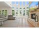 Spacious living room boasts a stone fireplace, a wall of windows and a large gray sectional at 100 Chateau Pl, Woodstock, GA 30188