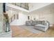 An open floor plan living room features hardwood floors, a fireplace, and a staircase to the second floor at 100 Chateau Pl, Woodstock, GA 30188