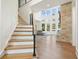 Bright living room features soaring windows, a stone fireplace, and hardwood floors at 100 Chateau Pl, Woodstock, GA 30188