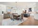 Open-concept living space with dining area, kitchen island, and stone fireplace at 100 Chateau Pl, Woodstock, GA 30188