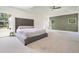 Inviting main bedroom featuring an accent wall, windows, and plush carpet flooring at 100 Chateau Pl, Woodstock, GA 30188