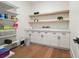 Organized walk-in pantry boasts custom white cabinets, wooden shelves, and marble countertops at 100 Chateau Pl, Woodstock, GA 30188