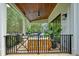 Covered patio with comfortable seating, ceiling fan, and stylish decor, perfect for outdoor relaxation and enjoyment at 100 Chateau Pl, Woodstock, GA 30188