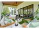 Spacious covered patio featuring stylish seating, pool views, and stylish lighting at 100 Chateau Pl, Woodstock, GA 30188
