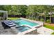 Relaxing backyard pool and hot tub area with lounge chairs surrounded by lush landscaping at 100 Chateau Pl, Woodstock, GA 30188