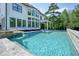 Backyard pool boasts a cascading waterfall, tanning ledge, and backyard views from the rear of home at 100 Chateau Pl, Woodstock, GA 30188