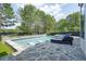 Inviting backyard pool with in-pool seating and luxurious lounge chairs at 100 Chateau Pl, Woodstock, GA 30188