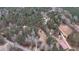 Aerial view showing home's wooded lot and surroundings at 791 Cross Plains Hulett Rd, Carrollton, GA 30116