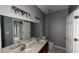Double vanity bathroom with updated light fixtures and tile floor at 791 Cross Plains Hulett Rd, Carrollton, GA 30116