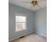 Light blue bedroom with ceiling fan and a window at 791 Cross Plains Hulett Rd, Carrollton, GA 30116