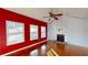 Living room with hardwood floors and red accent wall at 791 Cross Plains Hulett Rd, Carrollton, GA 30116