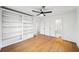 Bright bedroom with hardwood floors, built-in shelves, and ceiling fan at 2044 Wilandrew Dr, Decatur, GA 30033