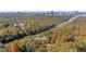 Aerial view of wooded property showcasing nearby access to highway and Atlanta's Battery entertainment district at 4070 Whitewater Creek Nw Rd, Atlanta, GA 30327