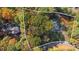 Aerial view of the property highlighting mature trees and the home's setting at 4070 Whitewater Creek Nw Rd, Atlanta, GA 30327