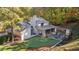 Beautiful backyard featuring a putting green, outdoor fireplace, and an expansive patio area at 4070 Whitewater Creek Nw Rd, Atlanta, GA 30327