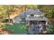 Aerial view of a home's backyard with a putting green, patio, and outdoor fireplace at 4070 Whitewater Creek Nw Rd, Atlanta, GA 30327