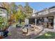 Stunning backyard patio with brickwork, comfortable lounge seating, and expansive sliding glass doors at 4070 Whitewater Creek Nw Rd, Atlanta, GA 30327