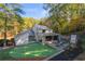 Backyard featuring a lush putting green, patio, fireplace, and outdoor seating perfect for relaxation and entertainment at 4070 Whitewater Creek Nw Rd, Atlanta, GA 30327