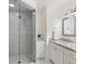 Bathroom features white vanity with granite countertop, a tiled shower with glass door, and modern fixtures at 4070 Whitewater Creek Nw Rd, Atlanta, GA 30327