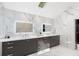 Bright bathroom features marble tile, dual sinks with lighted mirrors, and stylish gray cabinets with modern fixtures at 4070 Whitewater Creek Nw Rd, Atlanta, GA 30327