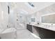 Spacious bathroom with marble flooring, a skylight, a soaking tub, dual vanity sinks, and a walk-in shower at 4070 Whitewater Creek Nw Rd, Atlanta, GA 30327