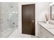 Modern bathroom featuring a tiled shower with glass door and white vanity with granite countertop at 4070 Whitewater Creek Nw Rd, Atlanta, GA 30327