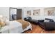 Cozy bedroom featuring hardwood floors, seating area, and a staircase to the upper floor at 4070 Whitewater Creek Nw Rd, Atlanta, GA 30327
