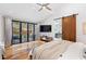 Bedroom featuring hardwood floors, ceiling fan, a sliding barn door and glass doors to the patio at 4070 Whitewater Creek Nw Rd, Atlanta, GA 30327