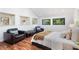 Bright bedroom featuring hardwood floors, recessed lighting, and lounge area with leather chairs and bench at 4070 Whitewater Creek Nw Rd, Atlanta, GA 30327