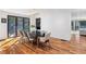 Bright dining room with wood floors, modern light fixture, and glass doors leading to the backyard at 4070 Whitewater Creek Nw Rd, Atlanta, GA 30327