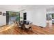 Bright dining room with wood floors, modern light fixture, and glass doors leading to the backyard at 4070 Whitewater Creek Nw Rd, Atlanta, GA 30327